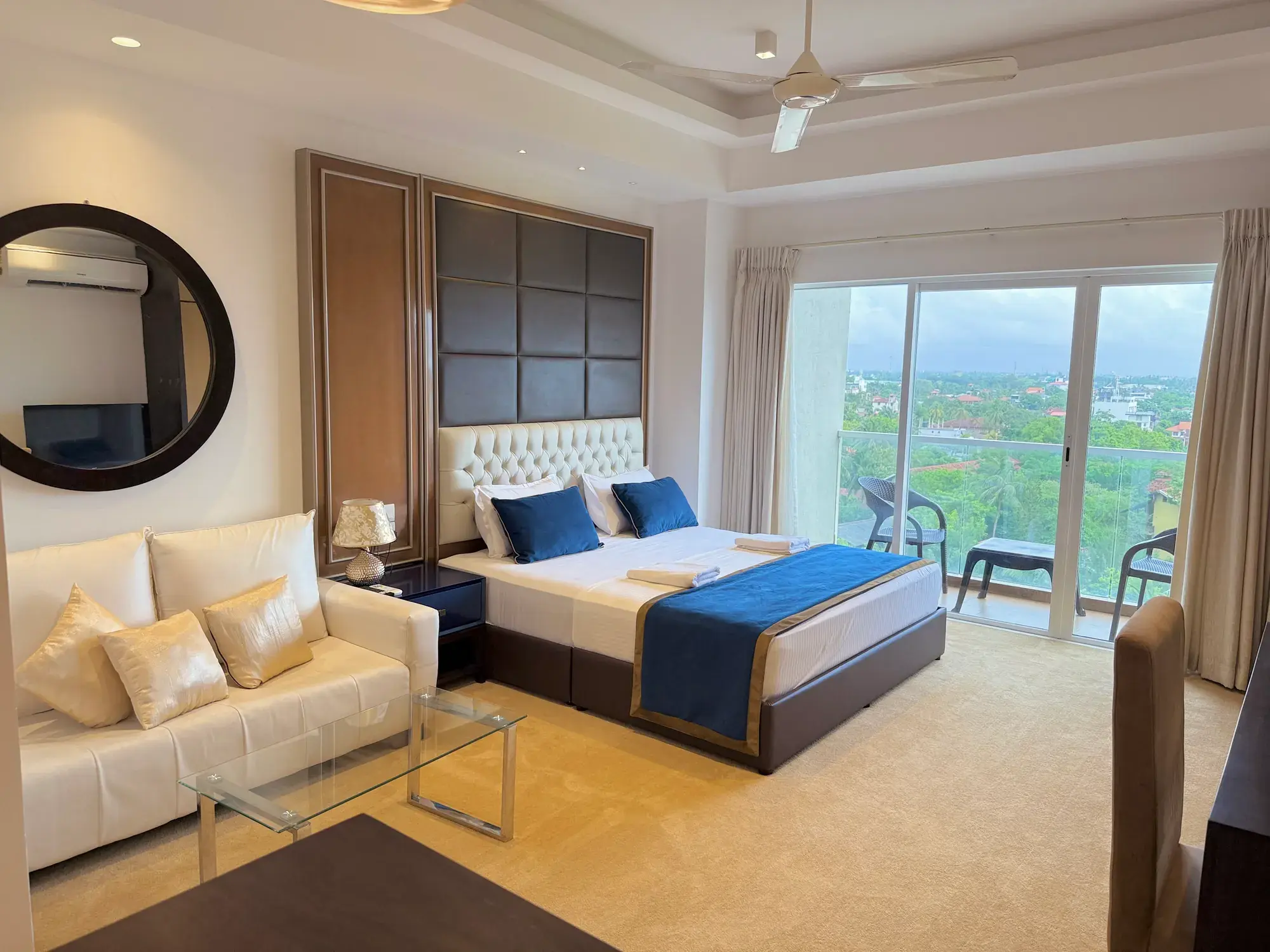 Bedroom with a sofa and floor-to-ceiling windows