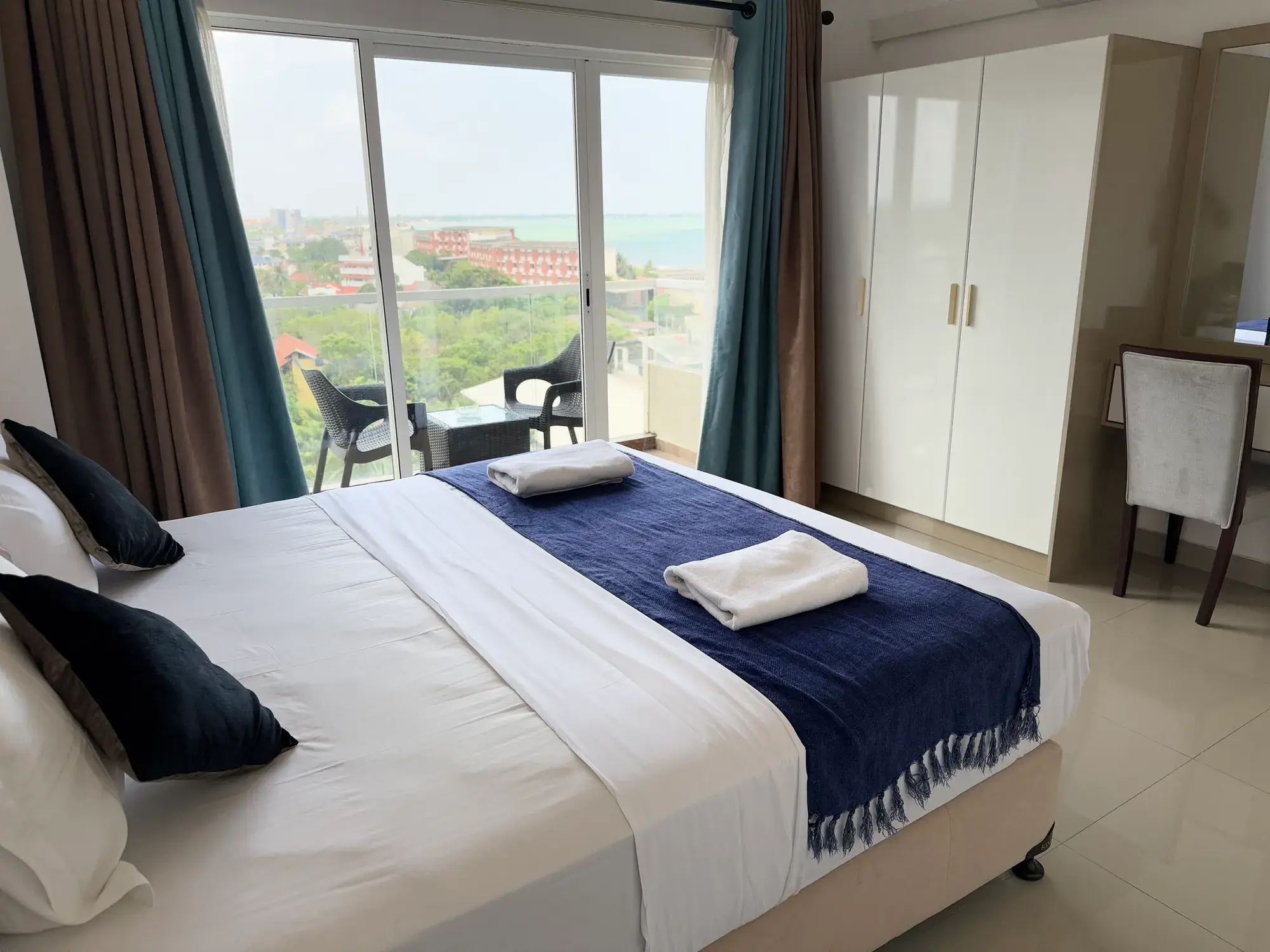 Bedroom with balcony doors and a wardrobe