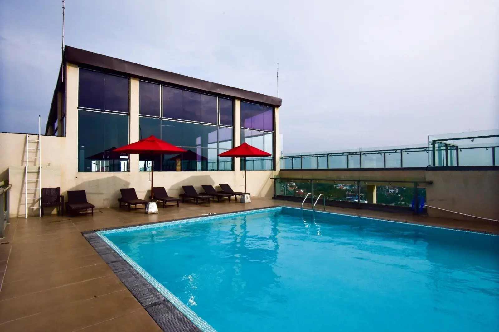 Sun loungers and umbrellas beside the rooftop pool